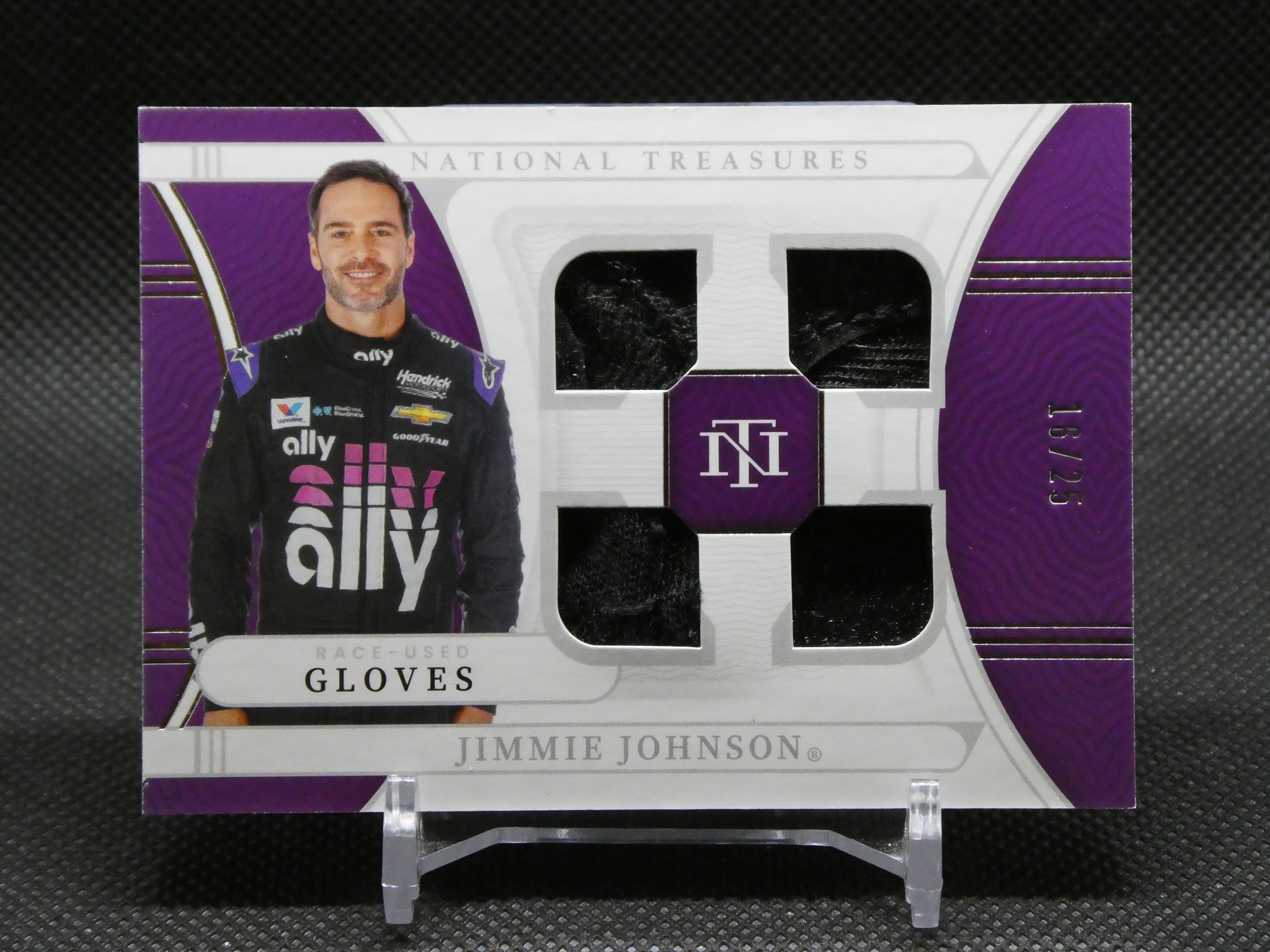 Purple National Treasures box featuring a driver image (Jimmie Johnson) and two glove compartments for collectible race-used gloves (front view).