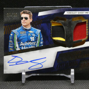 Trading card packaging featuring a NASCAR driver in a blue racing suit with sunglasses, next to a red gemstone graphic and a blue autograph at the bottom.