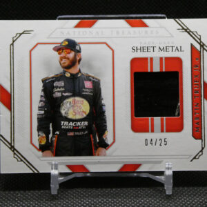 Collector's trading card showing a race car driver in a black racing suit with patches, on a white card with red border and a cut-out window behind him.