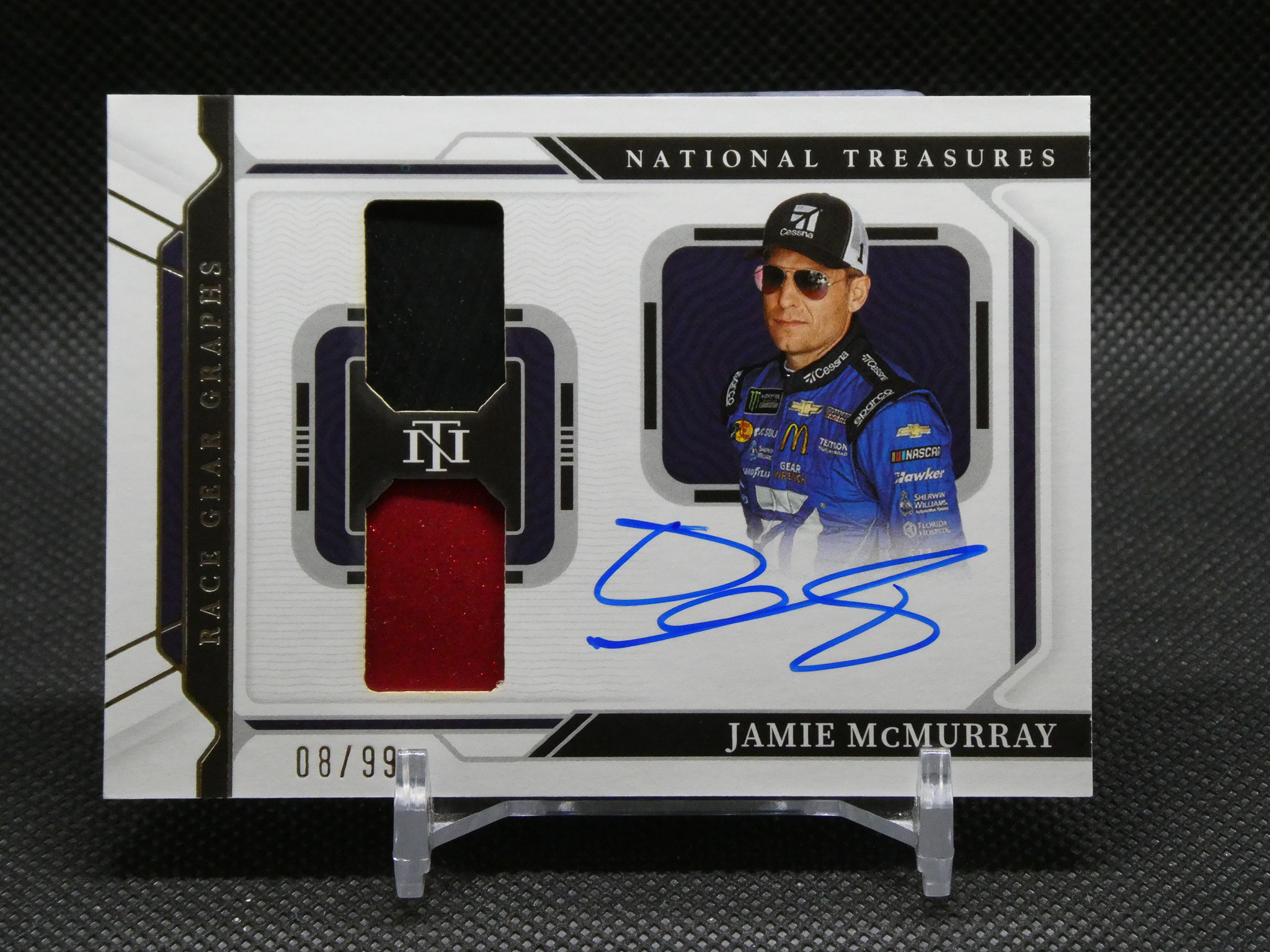 Jamie McMurray National Treasures trading card with a red fabric swatch and his autograph on the card edge.