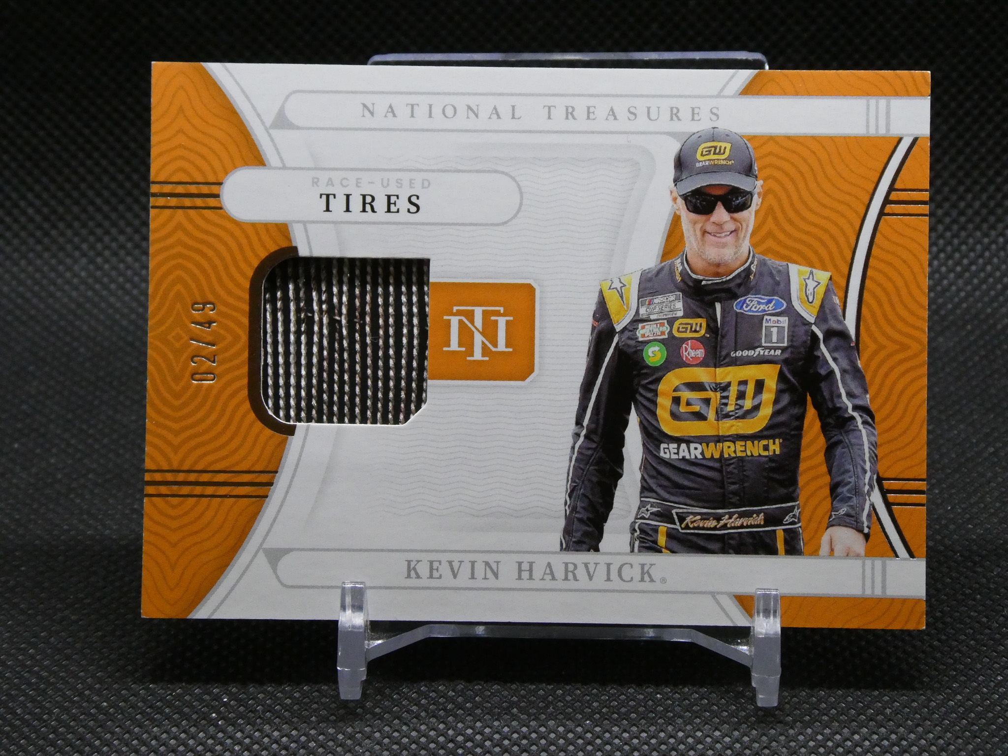 Trading card box featuring NASCAR driver Kevin Harvick in a racing suit, with orange and white graphics and the words 'National Treasures' and 'TIRES'.