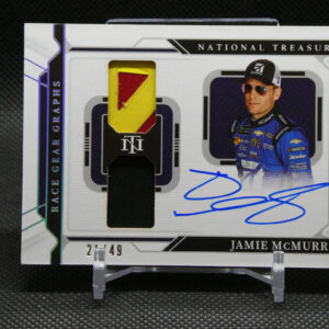Close-up of a Jamie McMurray NASCAR trading card with a yellow-red fabric patch inset, autograph in blue ink, and 'National Treasures' branding visible in the background.