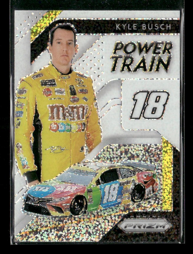 Trading card of NASCAR driver Kyle Busch in a yellow M&M's racing suit, standing beside a race car with number 18 and the words 'Power Train'.