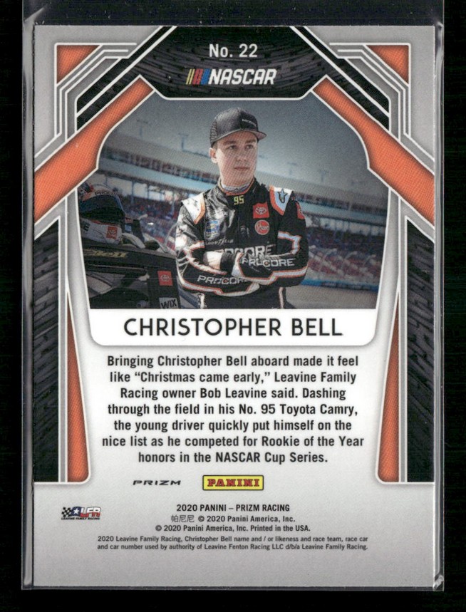 Front of a NASCAR trading card featuring driver Christopher Bell in a racing suit and cap, with 'Christopher Bell' printed below and a track background; Panini Prizm branding visible at the bottom.
