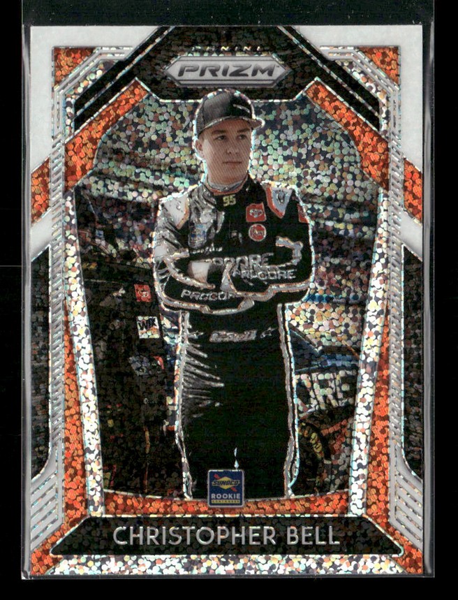 Trading card of NASCAR driver Christopher Bell in a black racing suit, with a glittery geometric Prizm border and his name at the bottom.