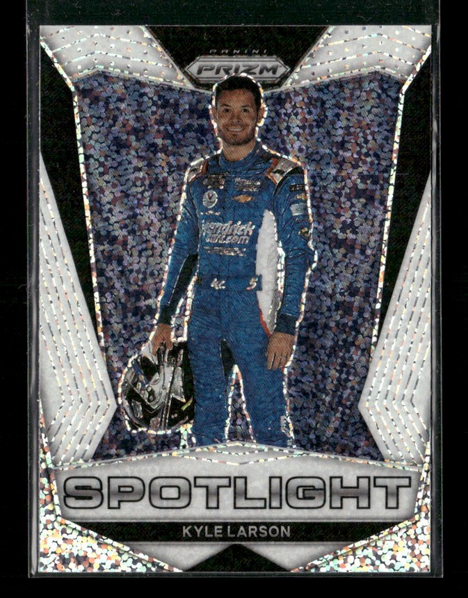 Kyle Larson in a blue racing suit standing with a helmet in hand on a Prism Spotlight trading card, confetti background.