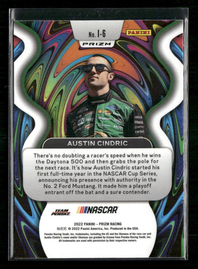 Panini Prizm NASCAR trading card featuring Austin Cindric: portrait in a green racing suit with sunglasses, set against a psychedelic swirl background, with bios text and NASCAR/Penske logos at the bottom.