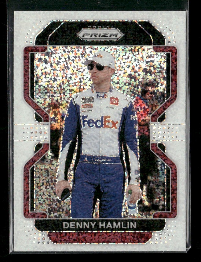 NASCAR driver Denny Hamlin in a white FedEx racing suit with blue sleeves, wearing sunglasses and a cap, on a holographic trading card.