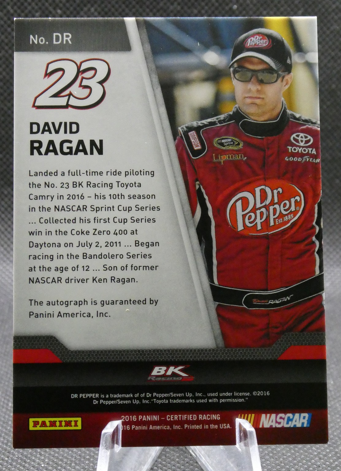 David Ragan NASCAR trading card: No. 23 on left, portrait in red Dr Pepper suit on right, with bio text and Panini logo below
