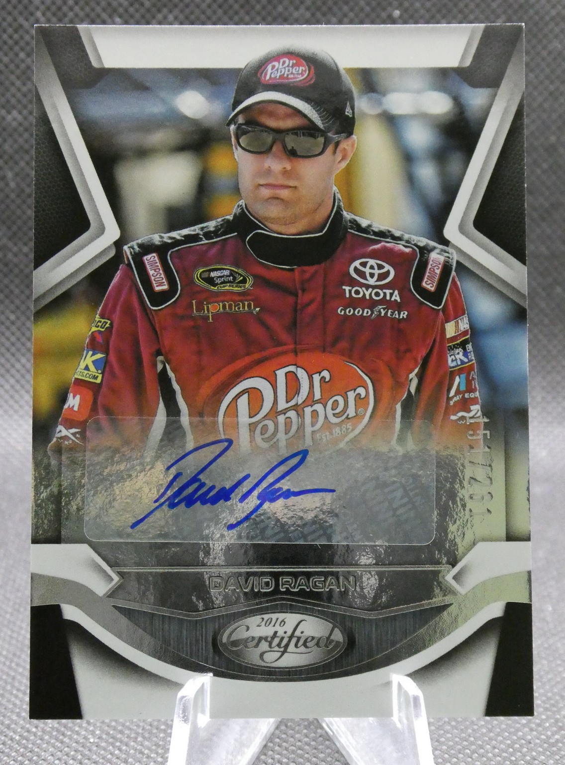 Autographed 2016 Certified trading card of NASCAR driver David Ragan in a red sponsor racing suit with Dr Pepper logo and sunglasses, signature in blue across the card.