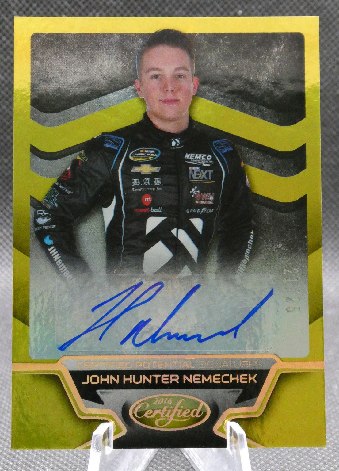 Autographed John Hunter Nemechek trading card with a yellow border and blue signature across the bottom panel.