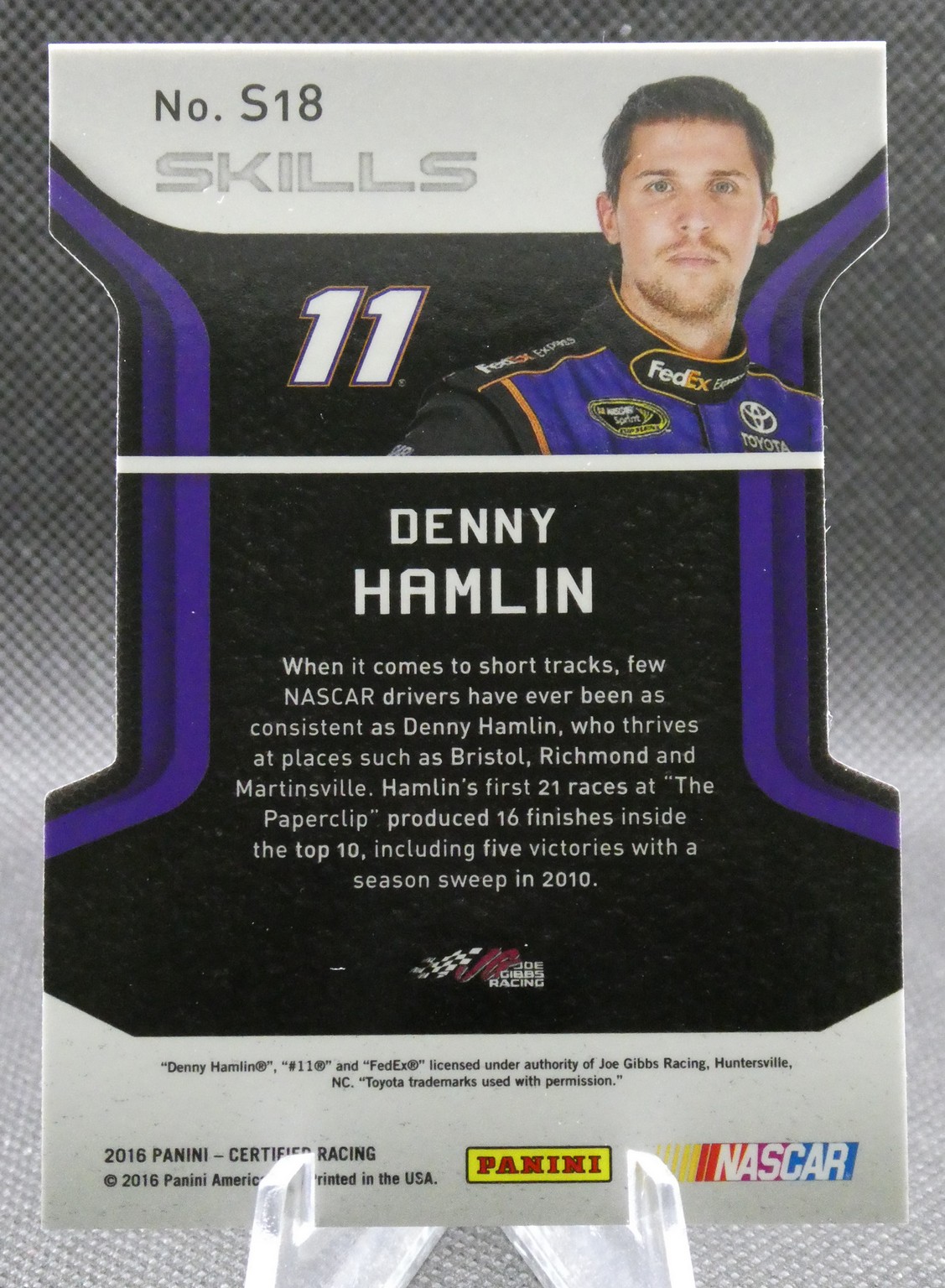 Denny Hamlin NASCAR trading card, No. 11, with a short bio on a black and purple background.
