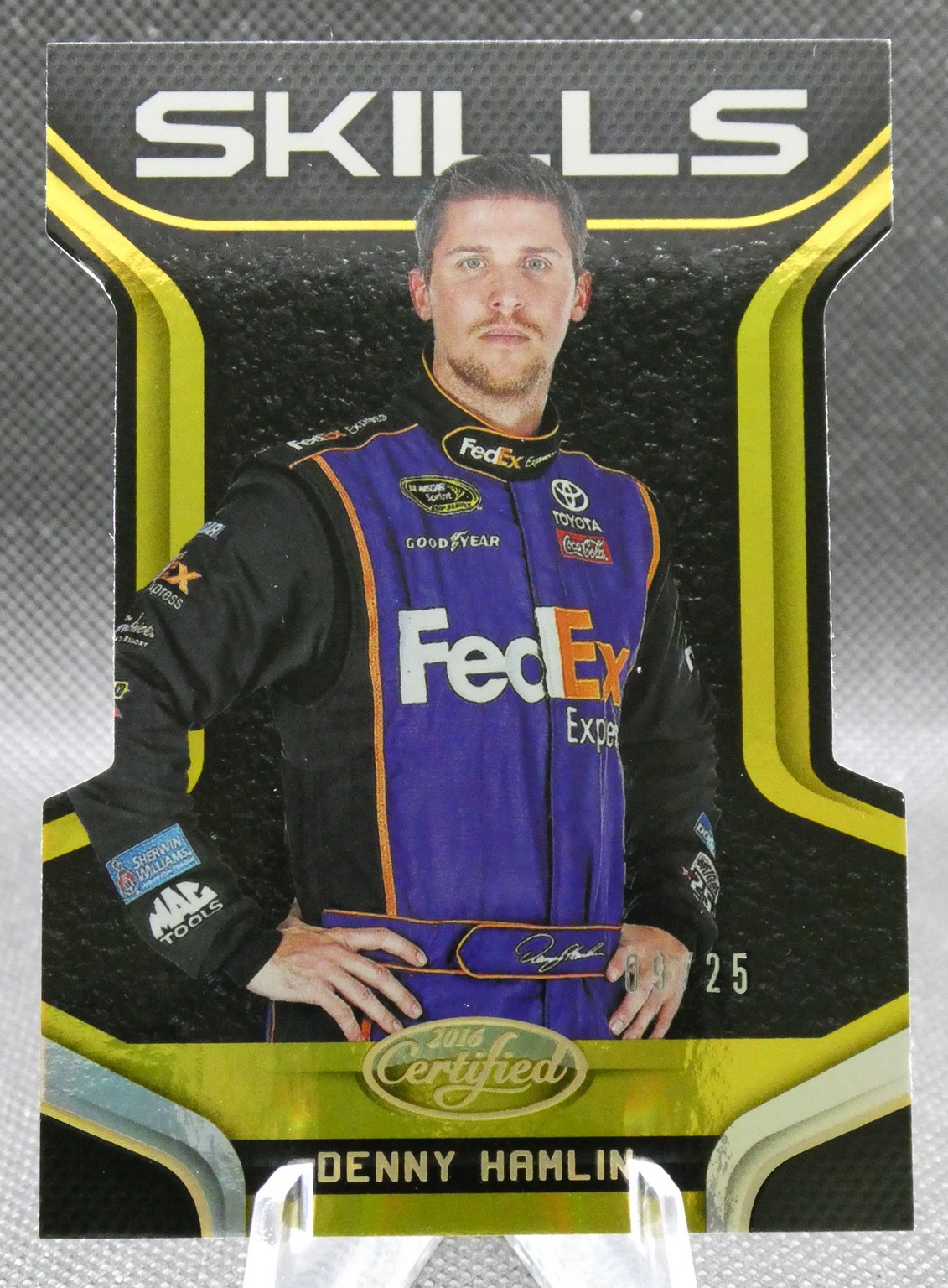 Denny Hamlin in a purple FedEx racing suit on a 'Skills' trading card with sponsor logos visible.