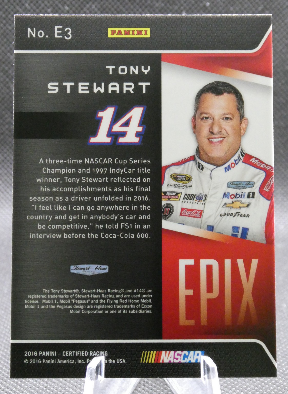 Trading card of Tony Stewart, No. 14, with bio text on the left and his portrait in a racing suit on the right (Panini).