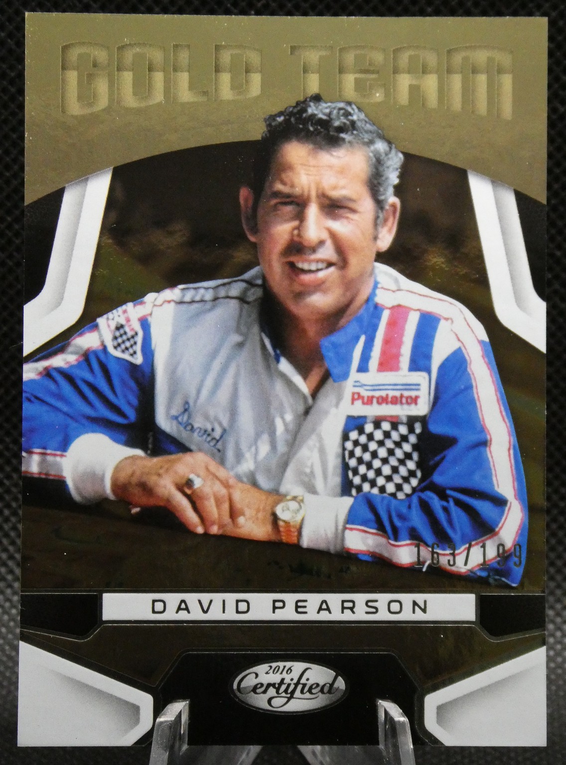 Trading card featuring NASCAR driver David Pearson in a blue-white racing suit under a Gold Team header.