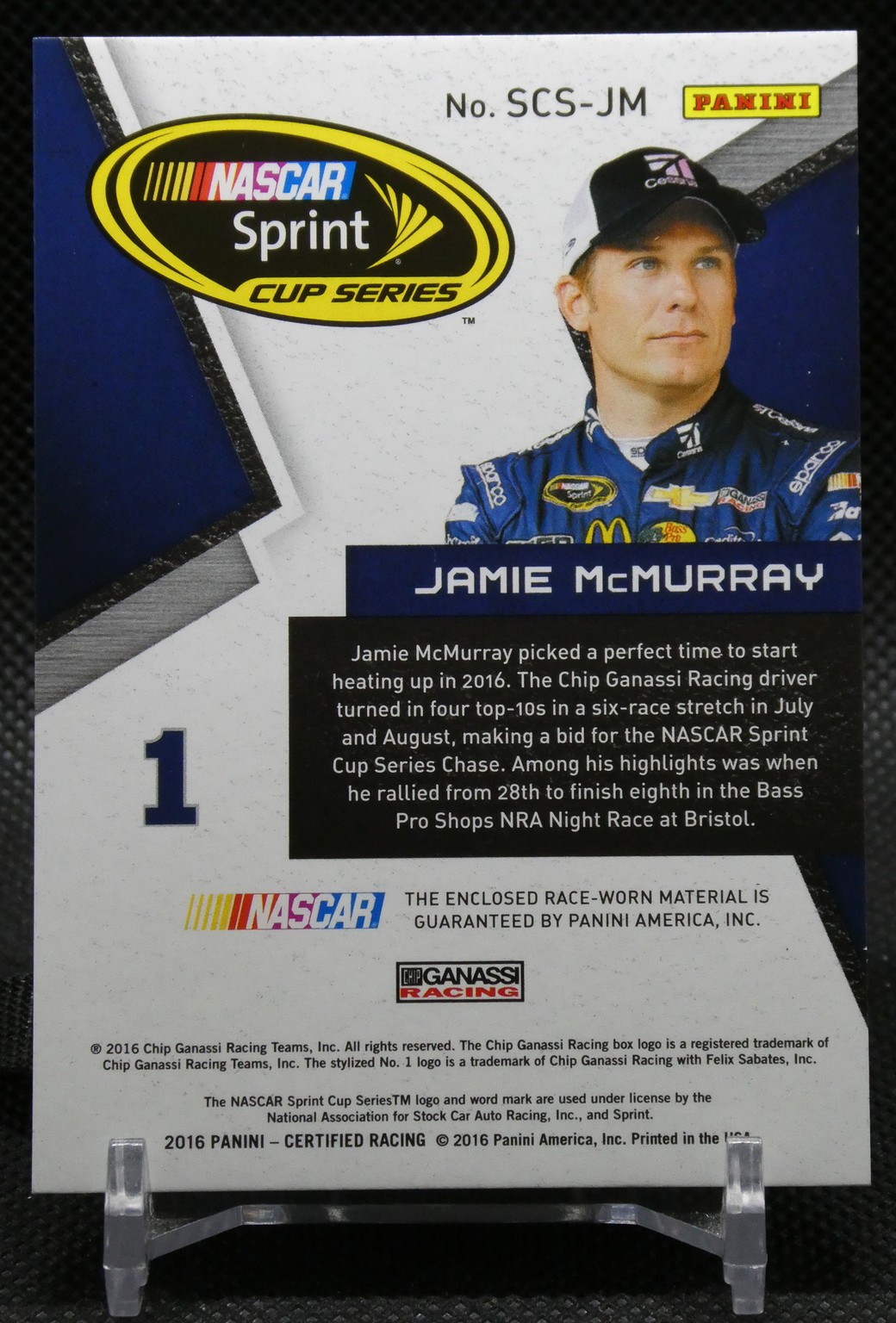 NASCAR Sprint Cup Series trading card featuring Jamie McMurray in a blue racing suit with sponsor logos and cap, looking to the side.