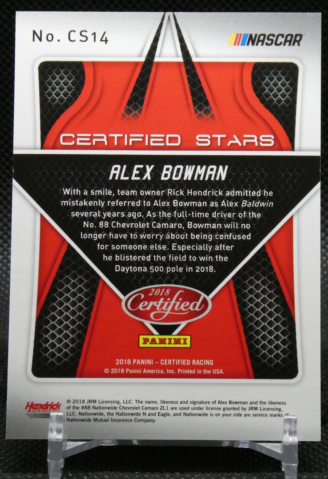 Back of a 2018 Panini Certified Racing card featuring Alex Bowman; NASCAR logo, red/black design, and a short bio text block.