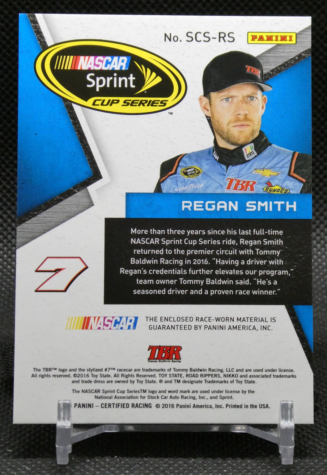 NASCAR Sprint Cup Series trading card featuring driver Regan Smith in blue race suit with Panini logo and a large yellow NASCAR logo in top left.