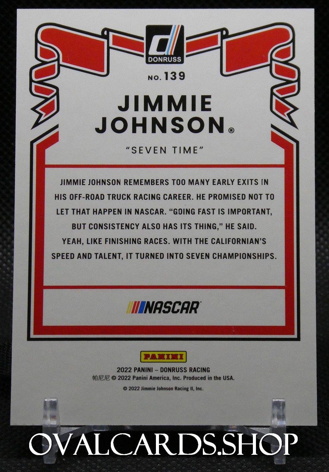 Trading card back for Jimmie Johnson featuring 'Seven Time', Donruss logo, NASCAR and Panini branding with a red bordered text area describing his career.