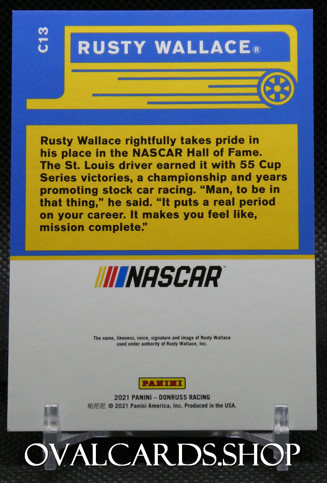 Back of a Panini NASCAR trading card featuring Rusty Wallace; blue and yellow design with a large text block about his NASCAR Hall of Fame entry and the NASCAR logo at the bottom.