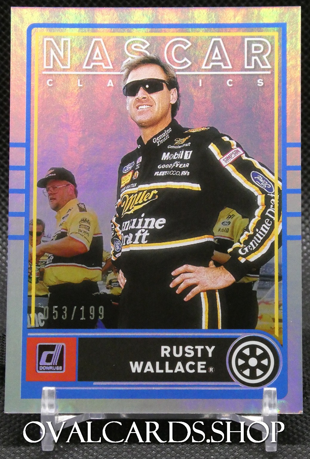 Holographic NASCAR Classics trading card featuring Rusty Wallace in a black racing suit with sponsor logos and a blue border.