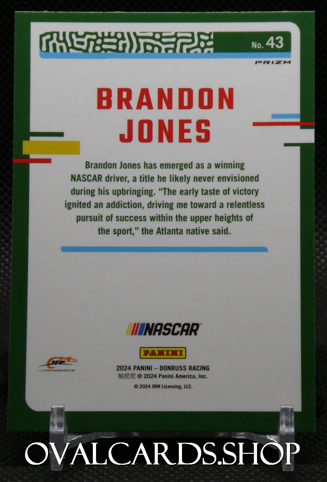 Brandon Jones NASCAR trading card with a green border, bold red name, and a paragraph about his rise to NASCAR fame; NASCAR and Panini logos visible.