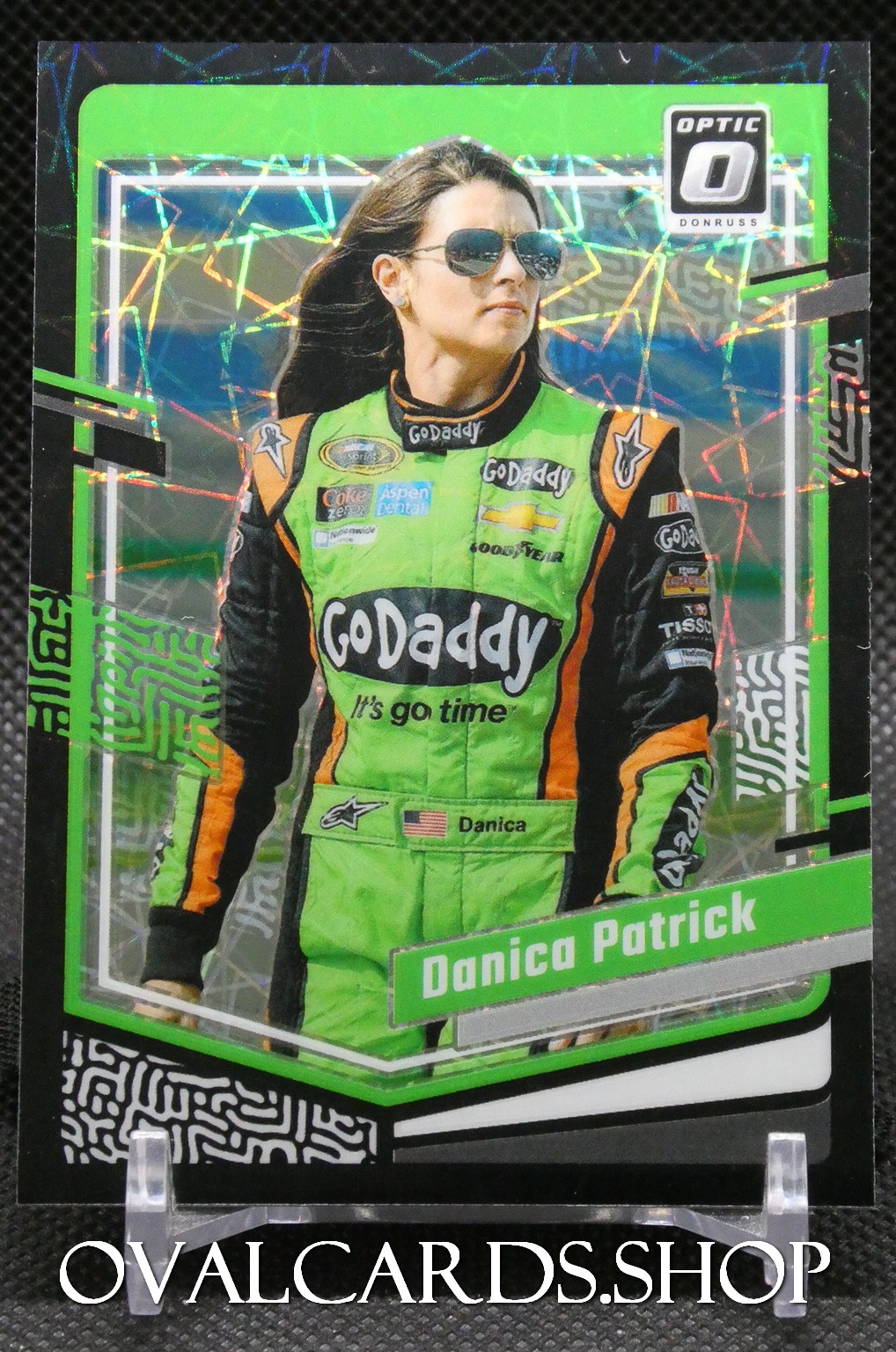 Trading card image of Danica Patrick in a neon green GoDaddy racing suit with a holographic backdrop.