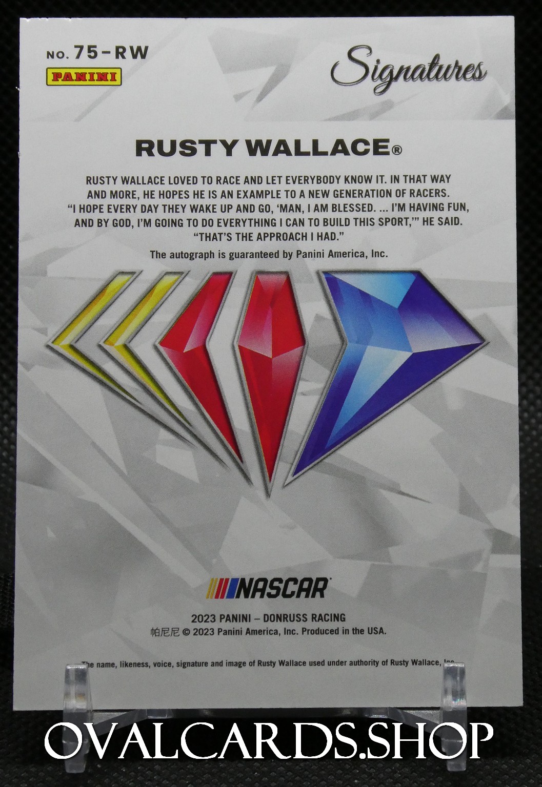 Back of Panini Signatures trading card featuring Rusty Wallace autograph, with multicolor diamond shapes and NASCAR logo at the bottom.