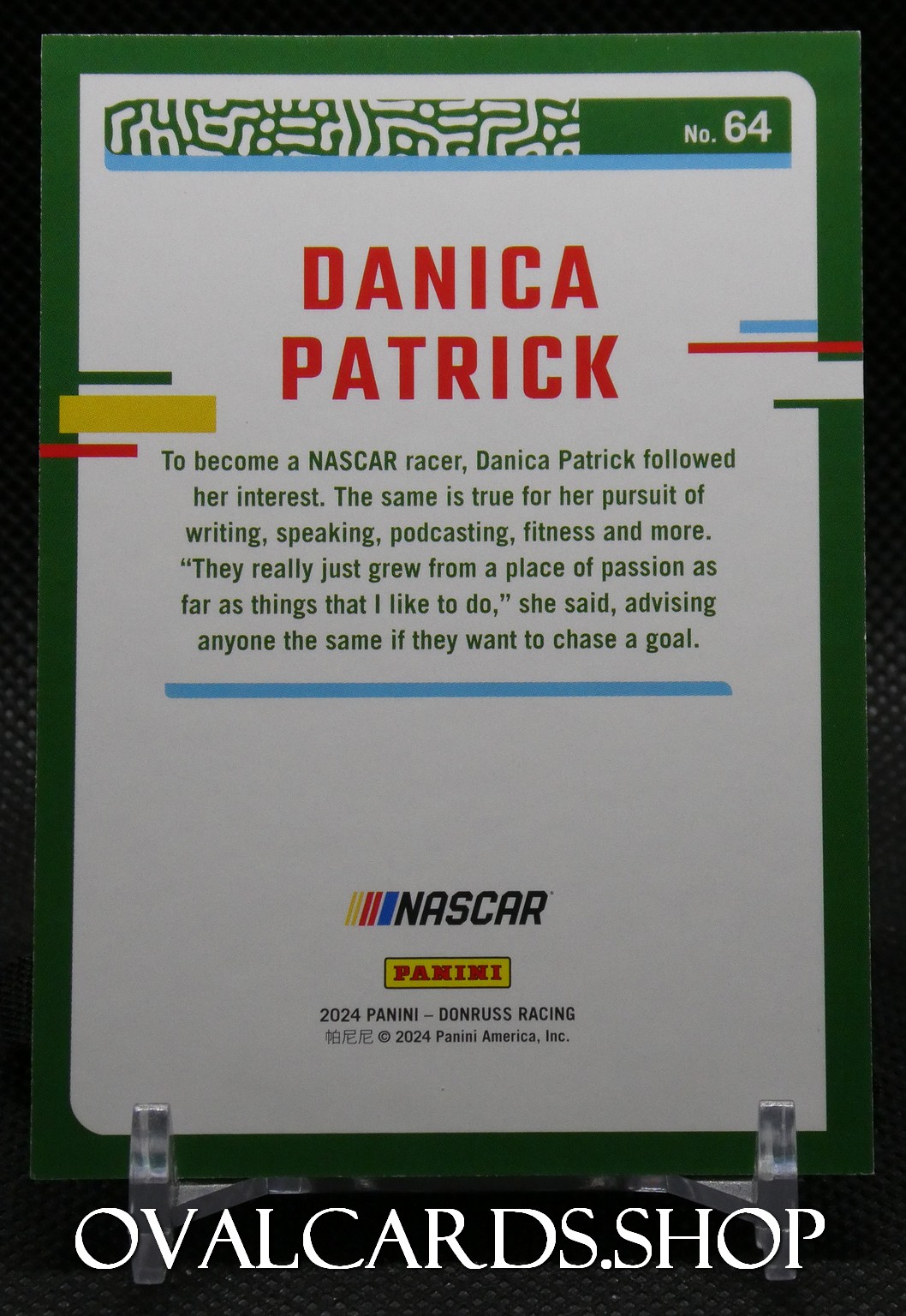 Back of a Danica Patrick NASCAR trading card with a green border, large red name, a paragraph about her racing career, and NASCAR and Panini logos at the bottom.