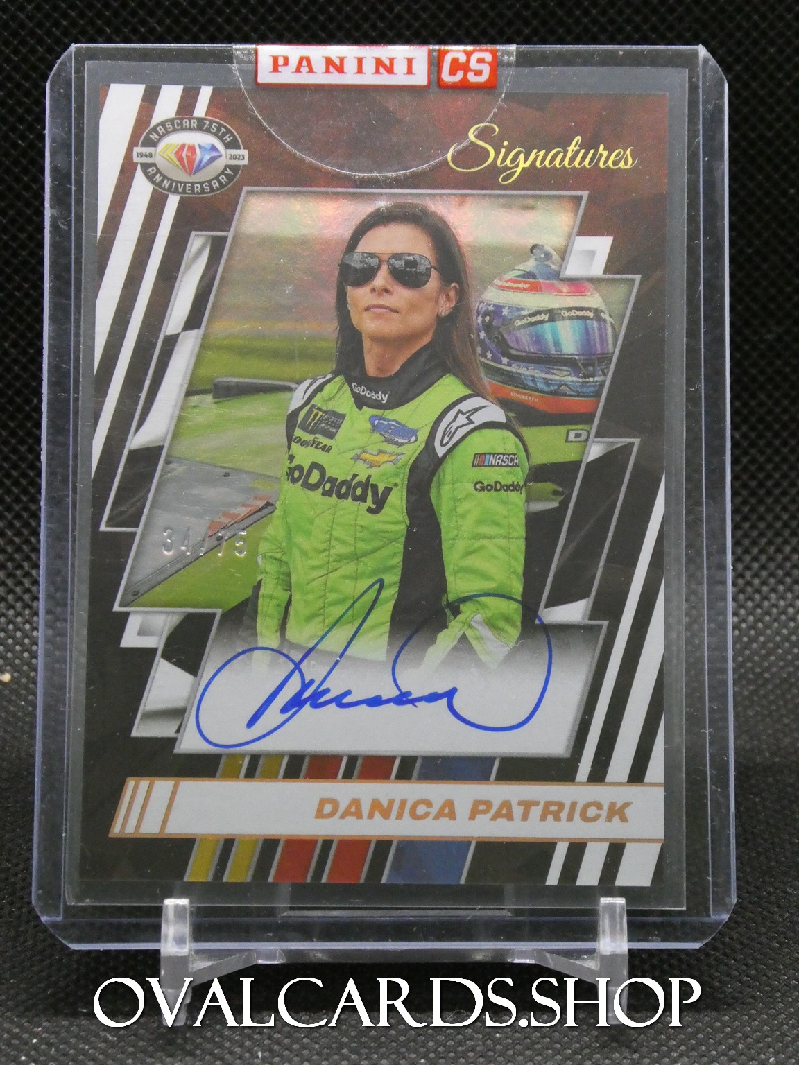 Panini Signatures card featuring Danica Patrick in a GoDaddy racing suit with sunglasses and a blue autograph.