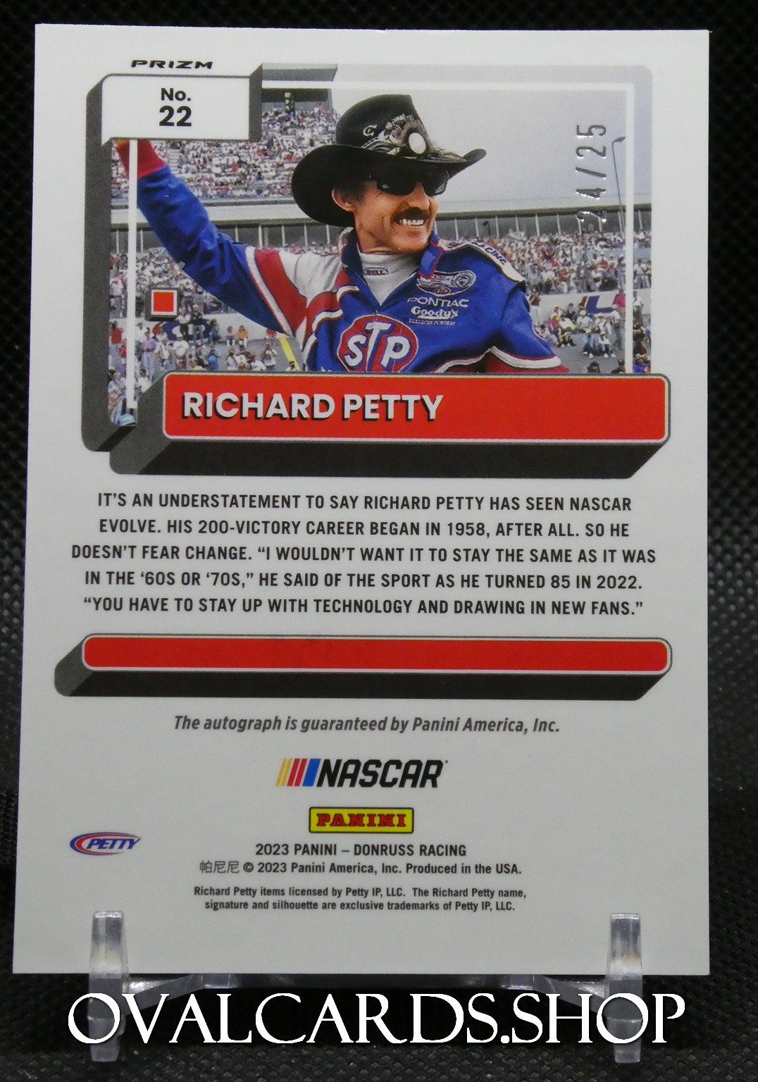 Trading card image of NASCAR legend Richard Petty in a blue racing suit, with a red RICHARD PETTY banner and crowd in the background; includes caption about Petty’s 200-win career and Panini/NASCAR branding.