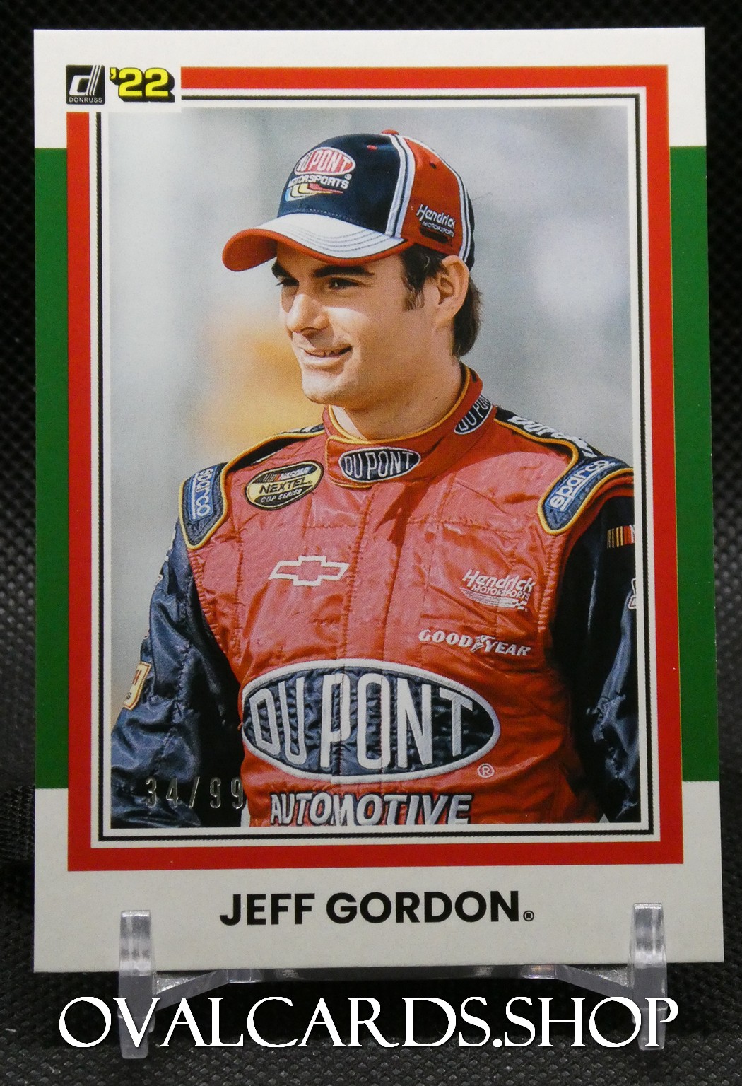 Jeff Gordon in a red DuPont racing suit with Hendrick Motorsports cap, posing for a 1992 Donruss card.