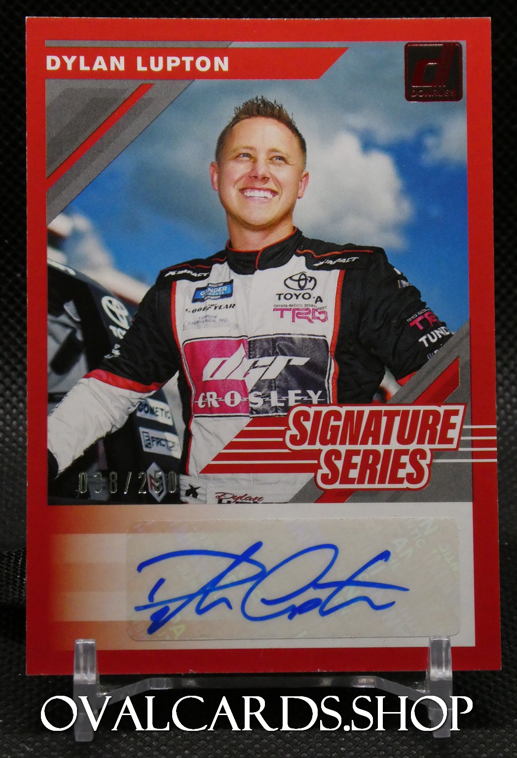 Dylan Lupton trading card from the Signature Series, featuring Lupton in a racing suit with sponsor logos and a blue autograph at the bottom edge.