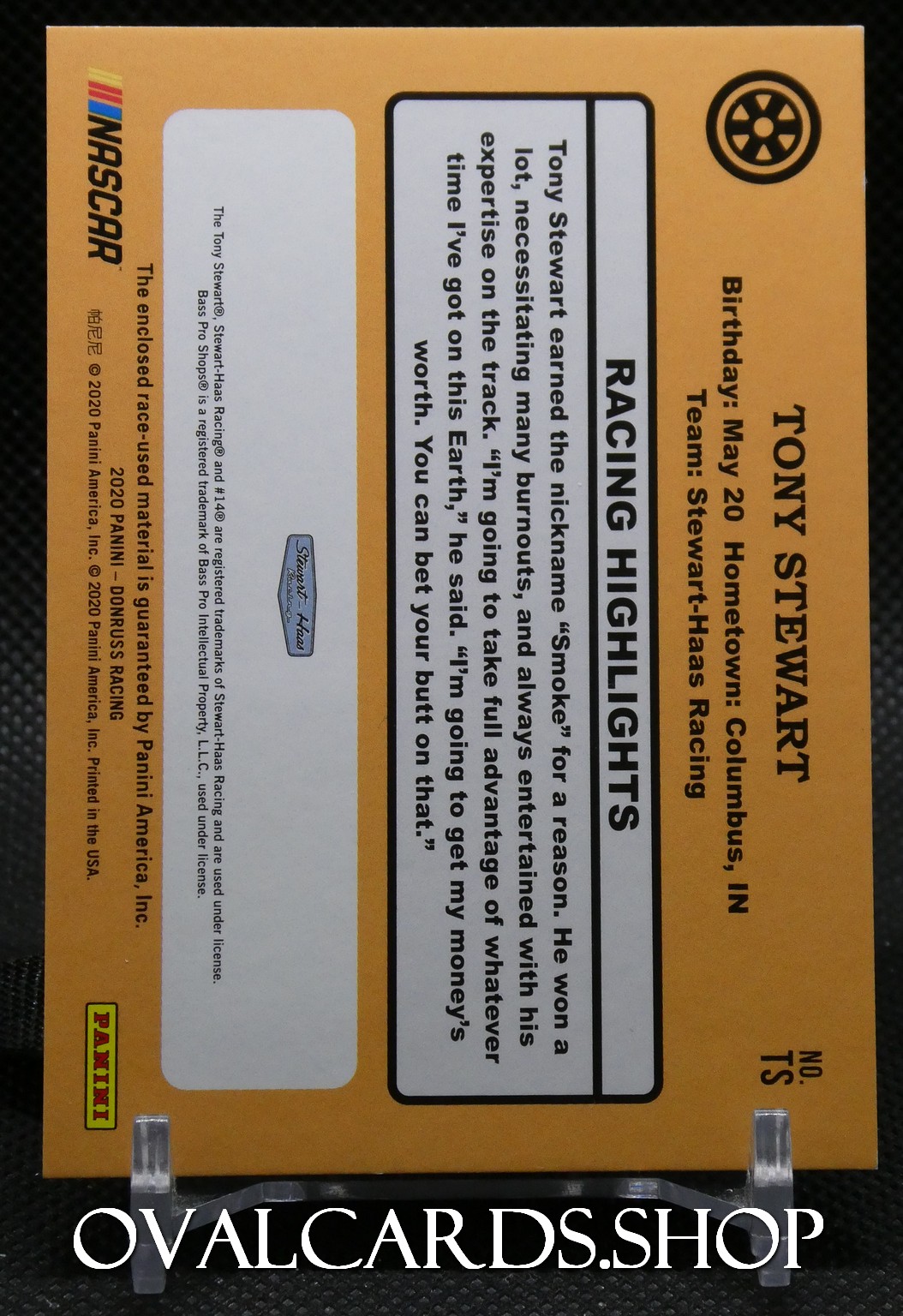 Orange Panini NASCAR trading-card packaging featuring Tony Stewart Racing Highlights text and a race-wheel icon; includes team name and birthday details.