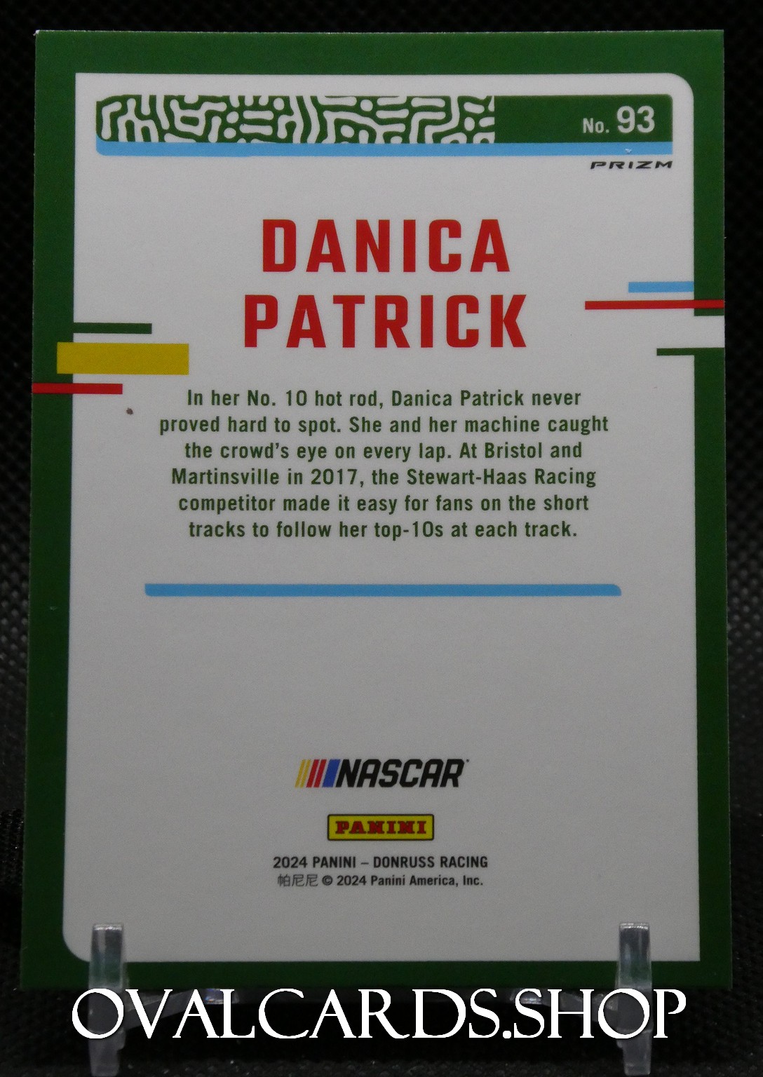 Front of a Danica Patrick NASCAR trading card with green border, showing her name in red and Panini/NASCAR logos.